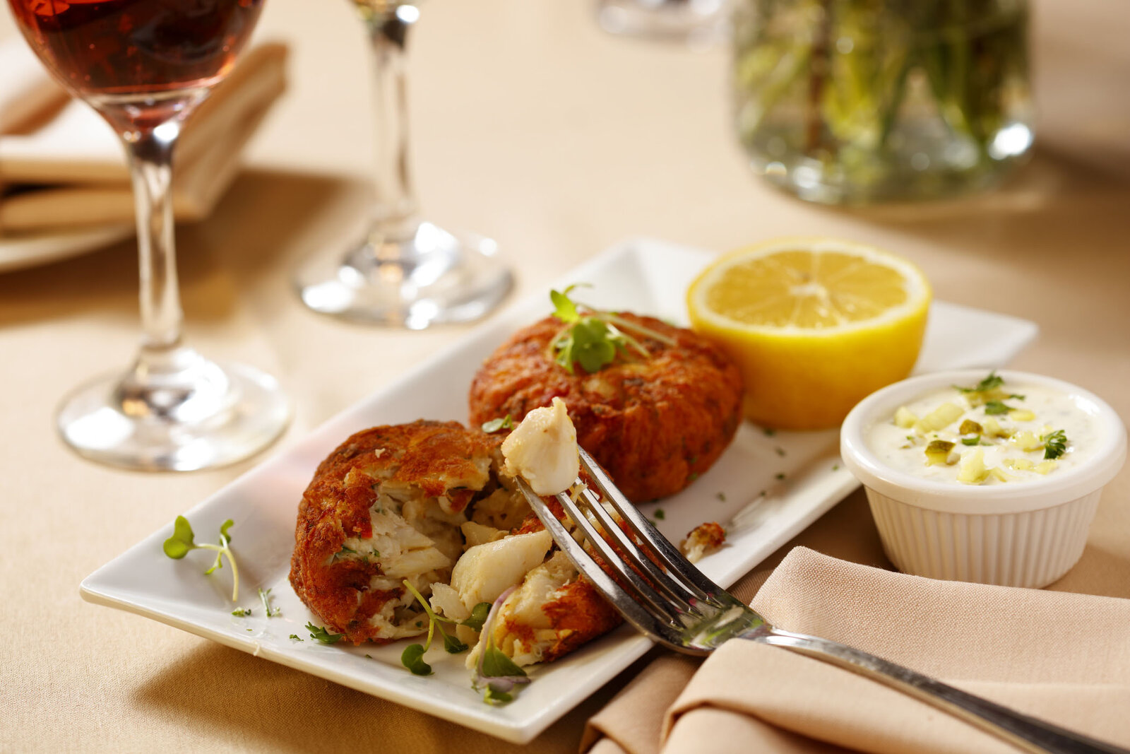 Crab cake plated with sauce