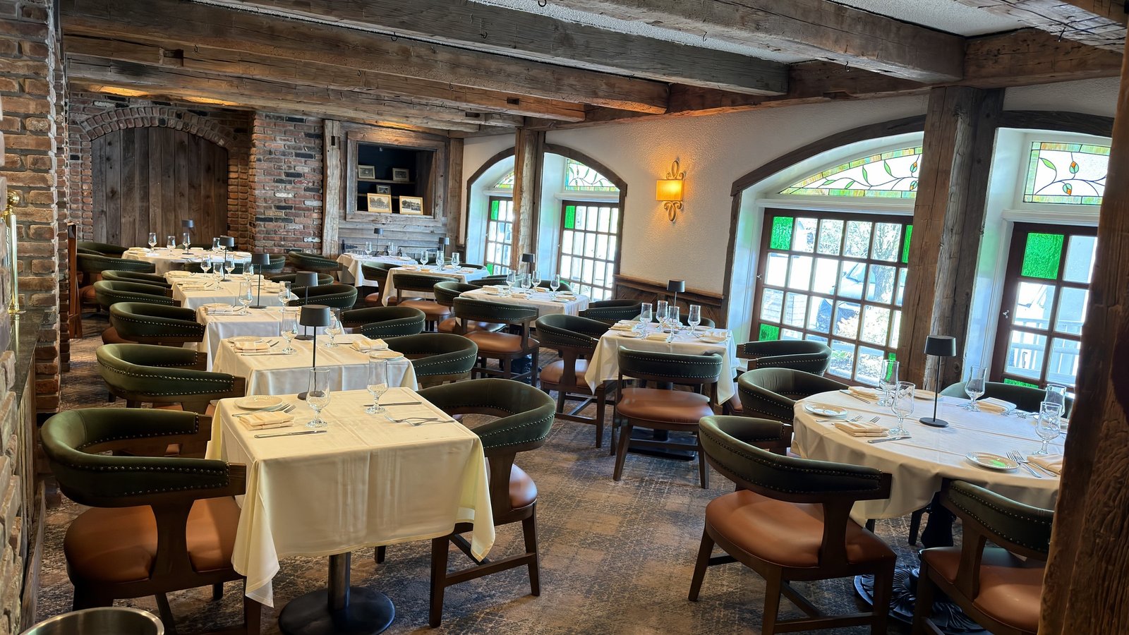 Tables set by the windows for a party