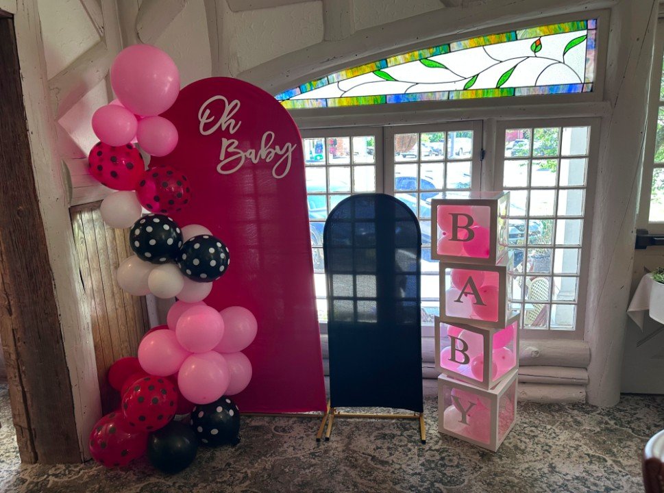 Balloon arch for a baby shower by the stained glass