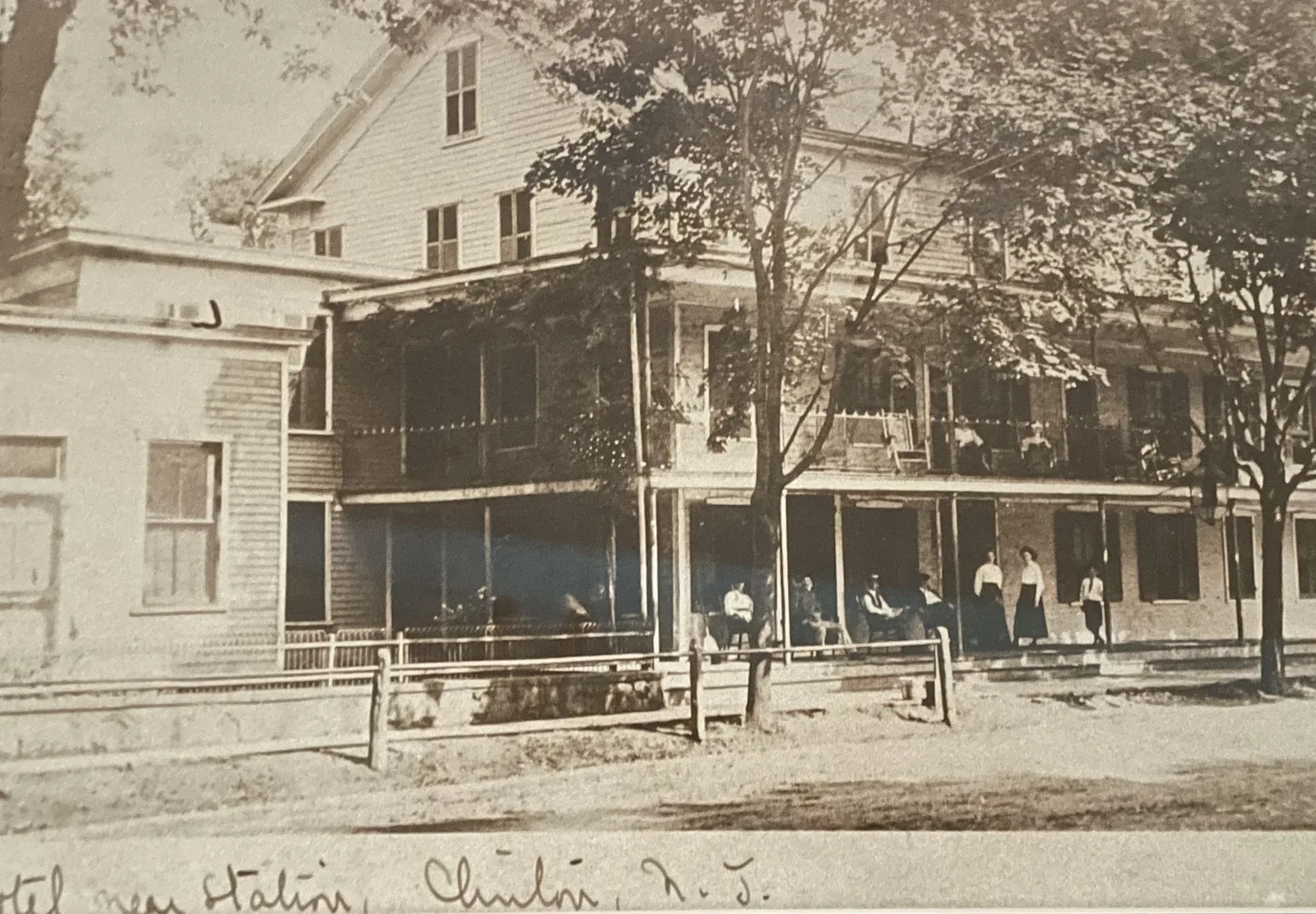 Guests on the porch of the Clinton House, captioned by hand: Hotel near Station, Clinton, N.J.