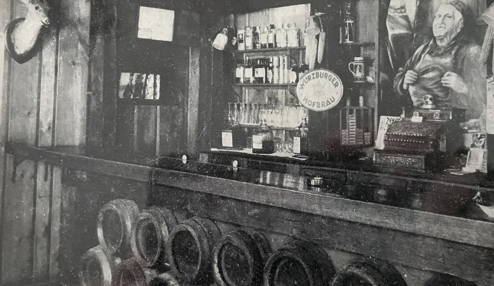 Barrels racked beneath the bar under a Würzburger Hofbräu sign